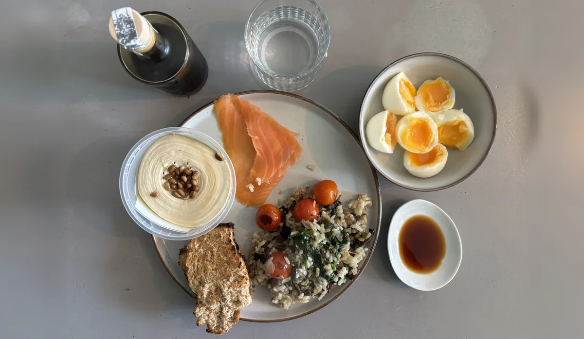 A 40 44 plate: smoked salmon, eggs, rice with spinach and tomatoes, hummus and toast
